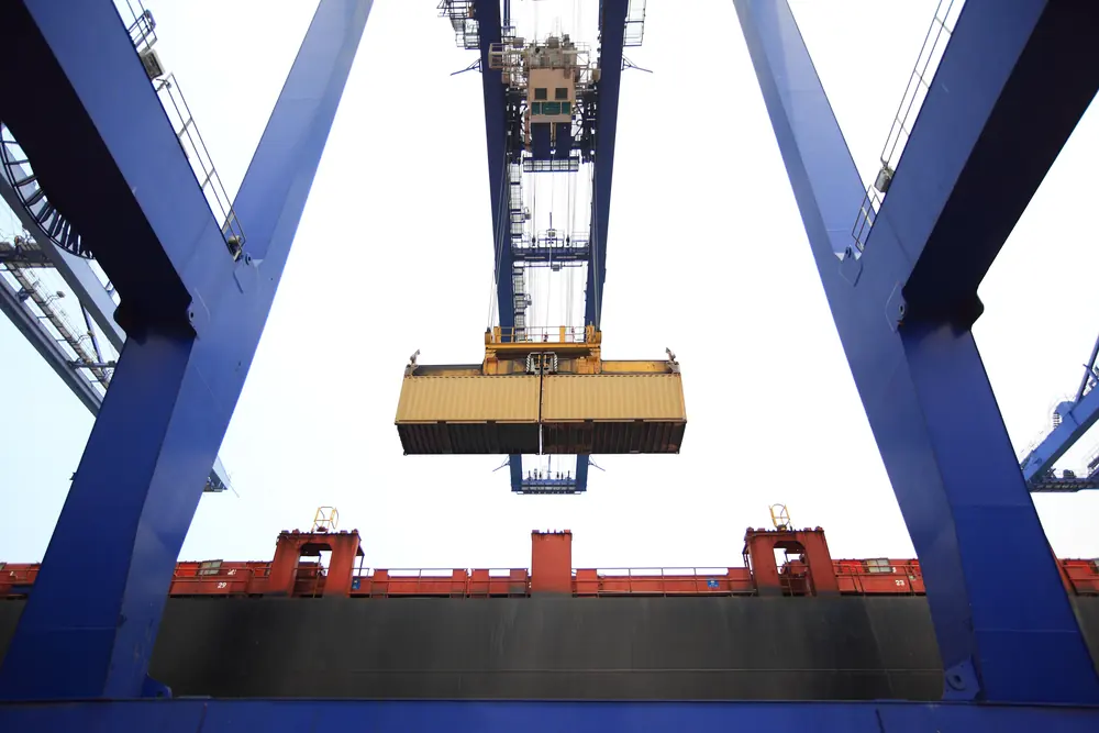 Crane lifting a shipping container