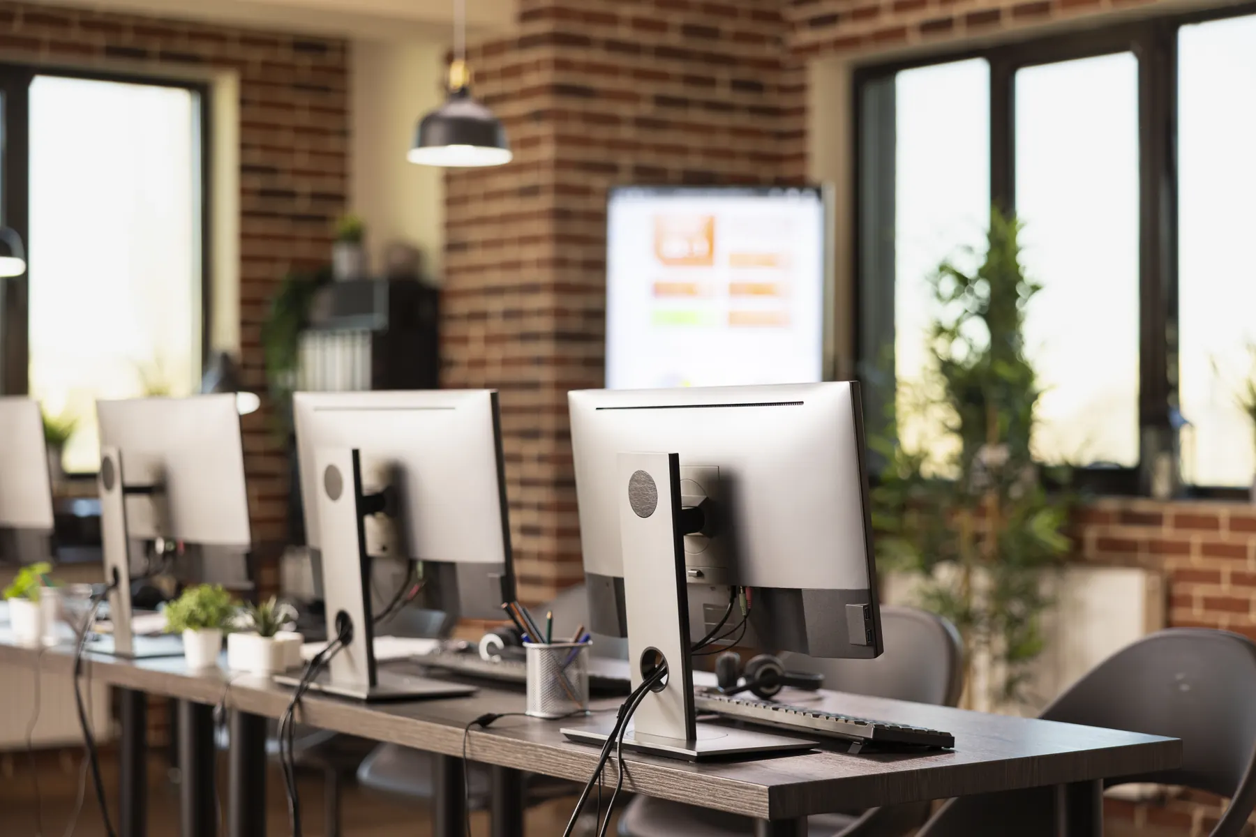 Lenovo business desktops and monitors on office workstations